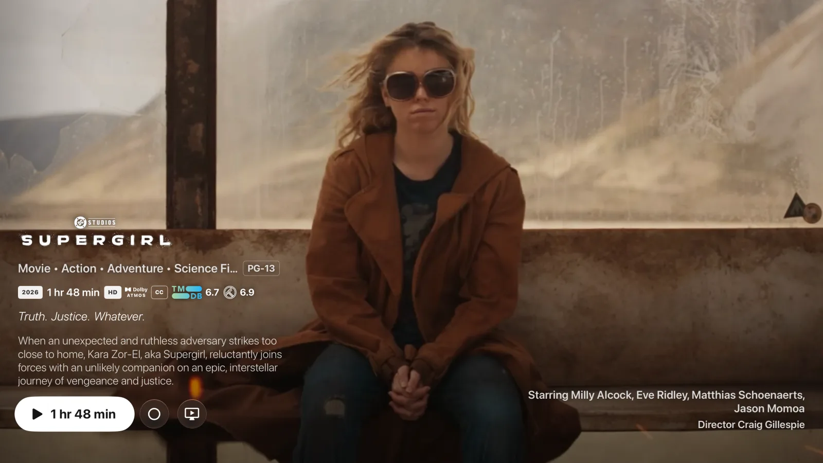 A movie detail page in Goody with the trailer playing full-bleed behind the title logo, ratings pills, and a focused Play button.